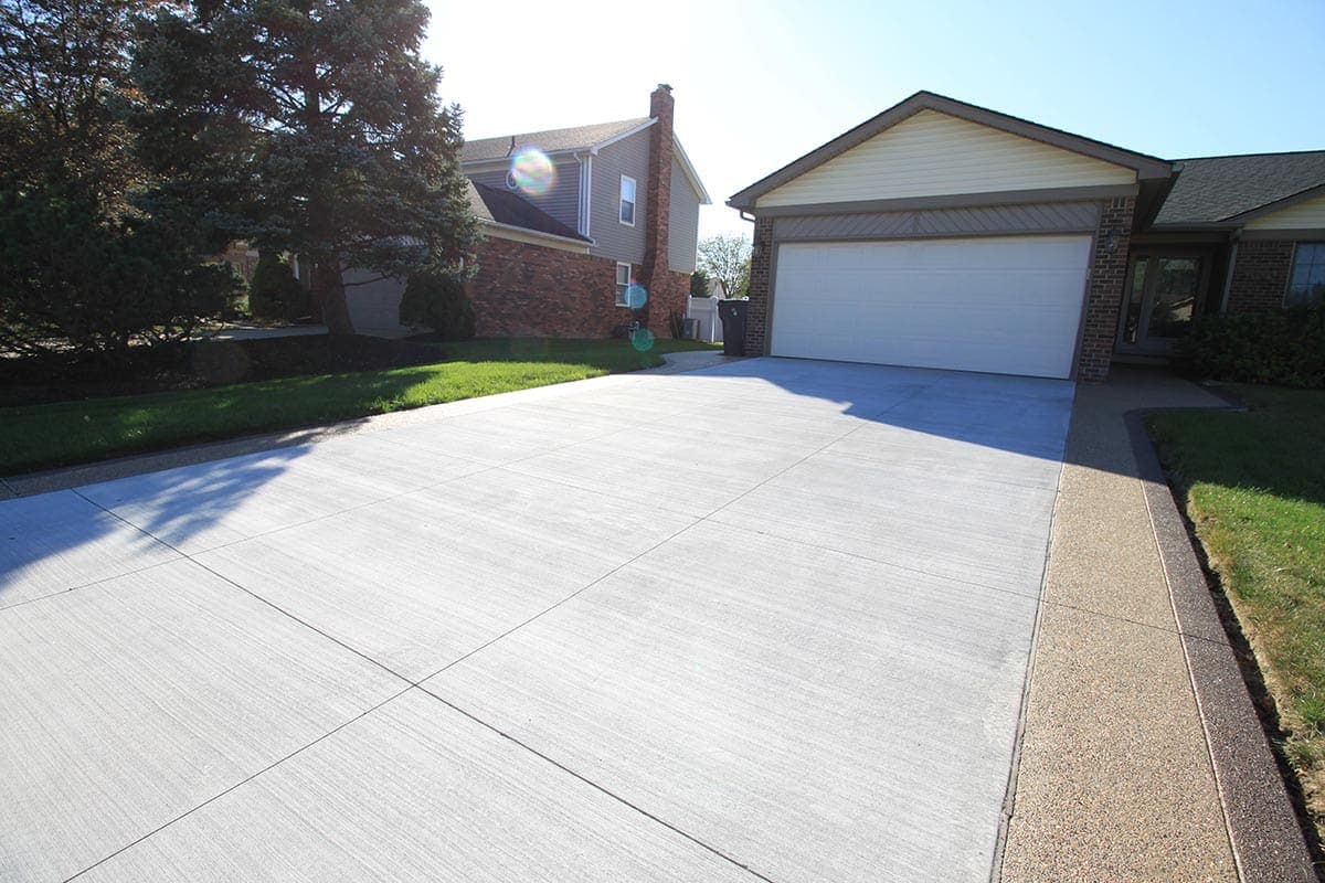 Clean concrete driveway with exposed aggregate border in Southwestern Ontario