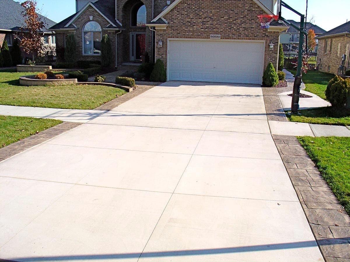 Concrete driveway with decorative stamped borders at an upscale home in Oxford County